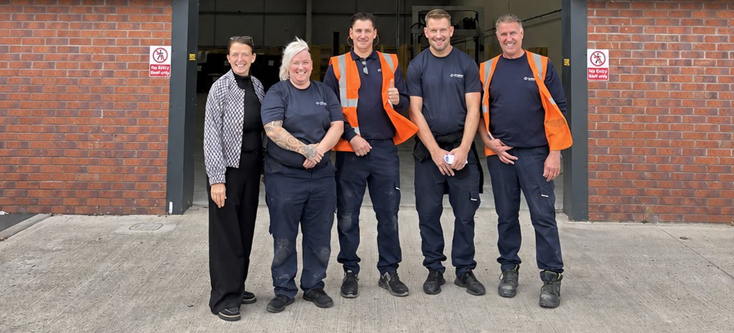 Five members of the Floryn team standing outside the loading bay at Clay Cross